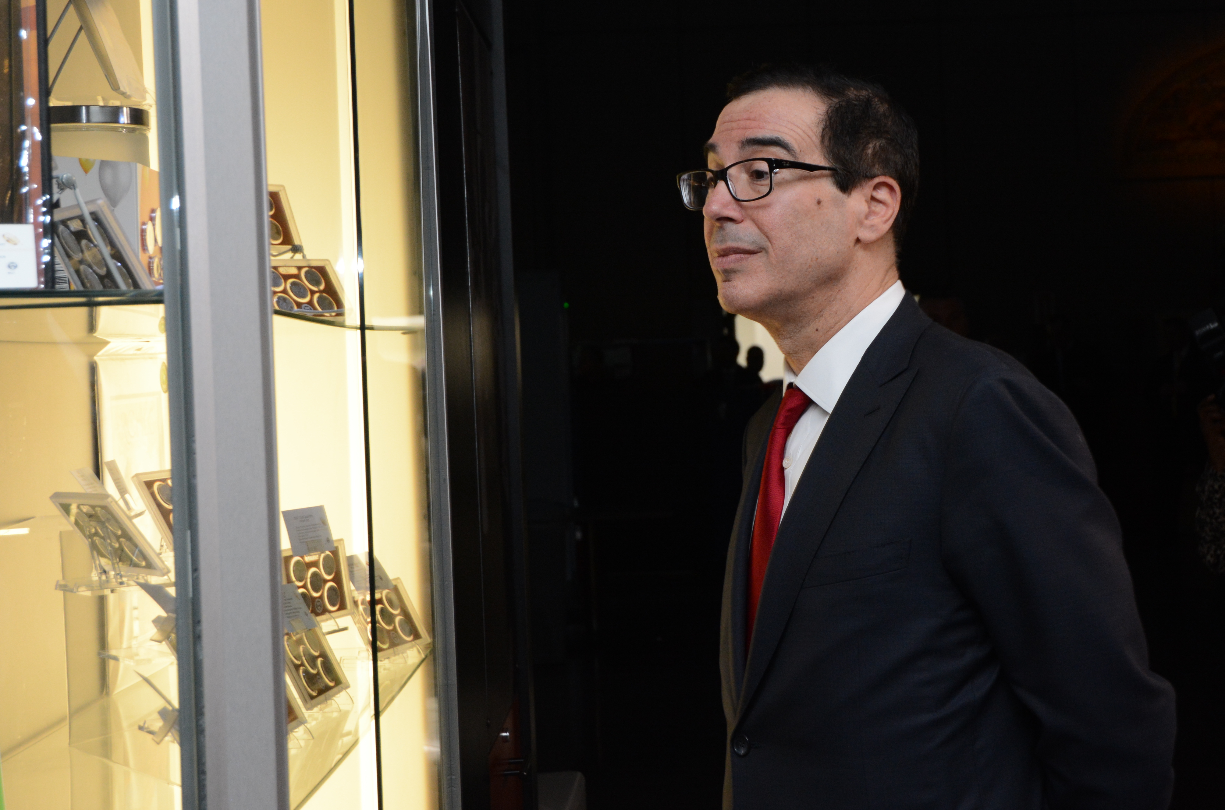 Treasury Secretary Steven Mnuchin looks at numismatic products at the gift shop following his visit of the U.S. Mint facility in Philadelphia. U.S. Mint photo by Jill Westeyn.
