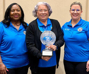 Director Gibson holds the Coin of the Year award