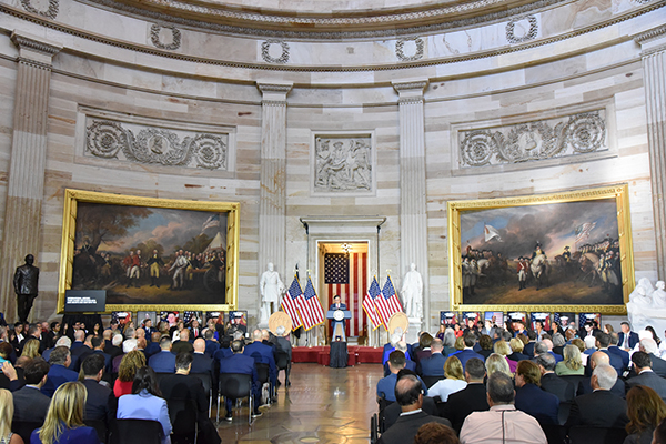 group of people seated in the Capitol Rotunda