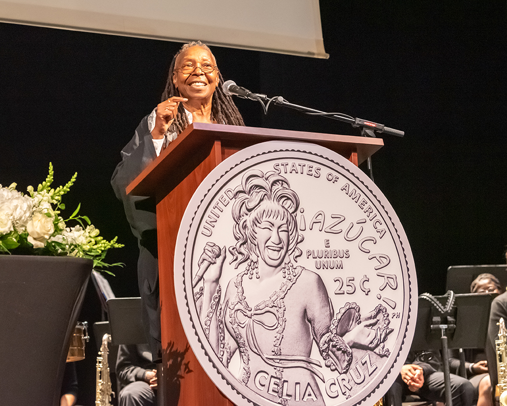 Whoopi Goldberg behind a podium